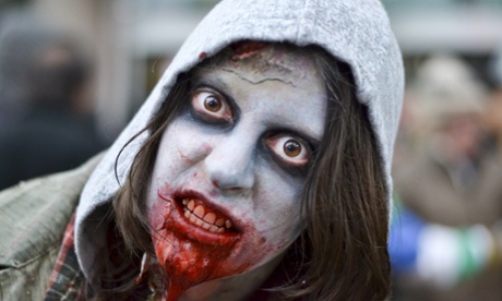 26 Oct 2013, Toronto, Ontario, Canada --- Toronto, Canada. 26th October 2013 -- The Toronto Zombie Walk continues to grow each year as hundreds took part in the annual event through the downtown area. -- Hundreds of the 'undead' braved the cold weather and gathered outside Nathan Philips Square to mingle with fellow participants dressed as zombies at Toronto's annual Zombie Walk.