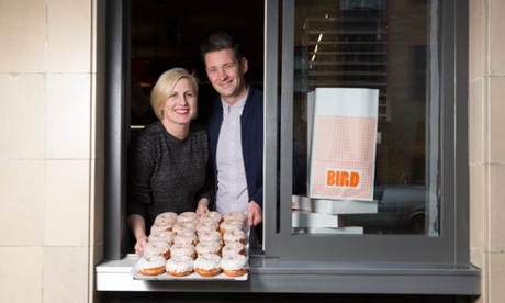 Paul and Clara pass a tray of doughnuts through the hatch at Bird in Islington.