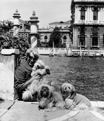 Peggy Guggenheim with her pet dogs outside her 18th-century Venetian palace on the Grand Canal,  1964.