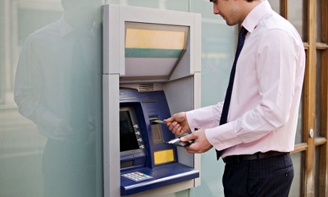 A businessman using a cash machine
