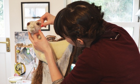 Jazmine Miles-Long works in her studio on building up the skull of an animal