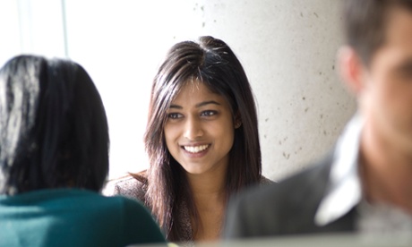 young woman smiling at another woman