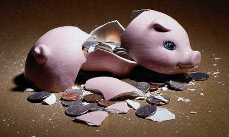 A broken piggy bank, with coins