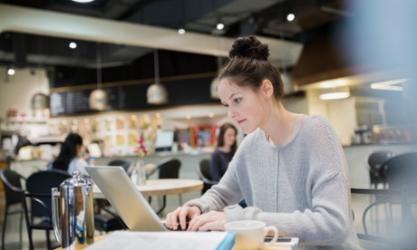 Woman on computer in cafe 