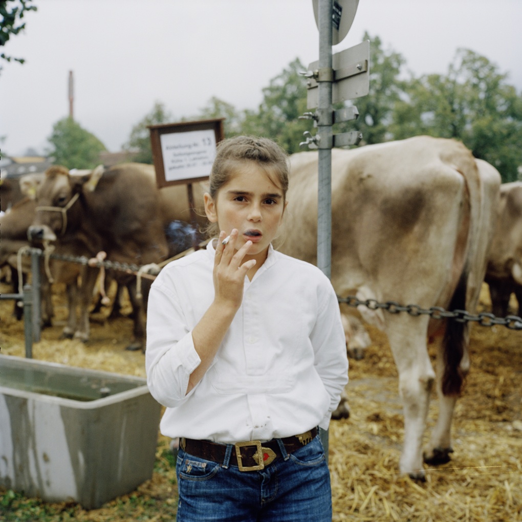 A girl smoking at a cattle show in Appenzell, Switzerland by Jiri Makovec