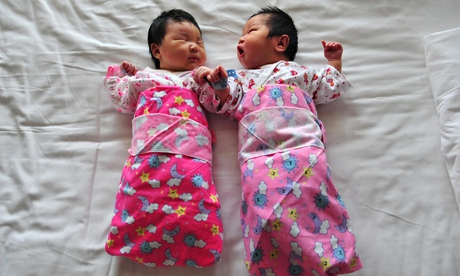A newborn babies lie on a hospital bed i