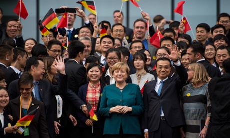 German chancellor Angela Merkel and Chinese premier Li Keqiang pose with students in Hefei, China, 30 October.