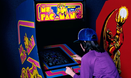 A teenage girl plays Ms Pac-Man in 1989.