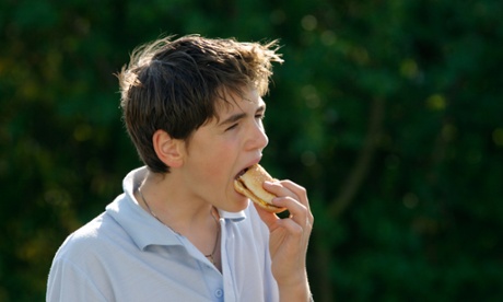 young boy eating burger