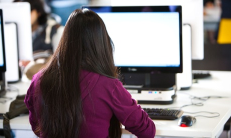 A female student sitting at a computer