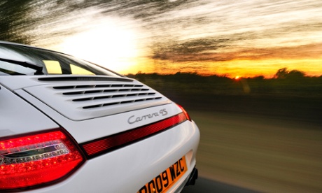 A Porsche Carrera drives into the distance. The company will include Apple's CarPlay, not Android Auto, in its 2017 911.