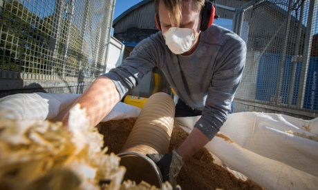 David Ousby, director of Cambridge Wood Fuel, vacuuming joinery workshop dust and shavings for briquettes.
