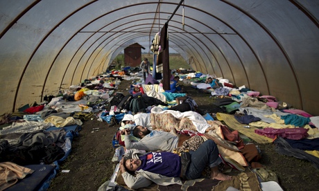 Syrian people sleep inside a greenhouse at a makeshift camp for asylum seeker, southern Hungary