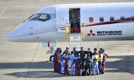 Flight crew members form a circle before the Mitsubishi Regional Jet's maiden test flight.
