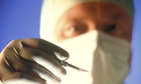 Surgeon holding scalpel
