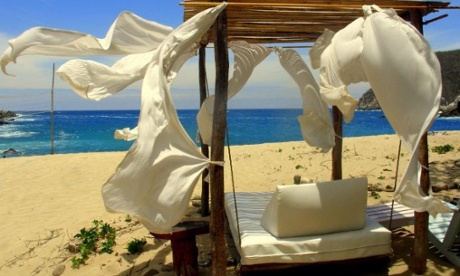 Beach lounger on the sand with a view of the sea at Bahia de La Luna, Pochutla, Oaxaca, Mexico