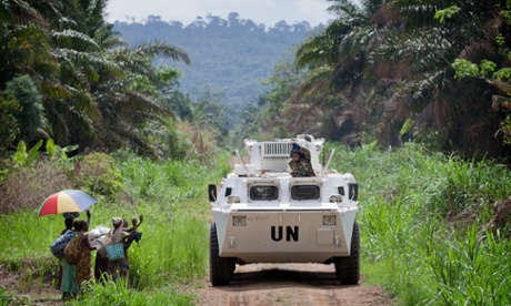Residents in Beni region of Congo greet UN peacekeeper passing by in an armoured personnel carrier