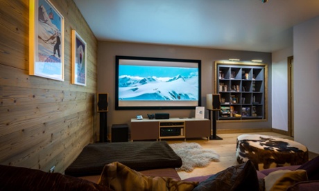 Lounge area, with large wall-mounted TV, rugs and bookshelves at Chalet Twenty26, Morzine, France