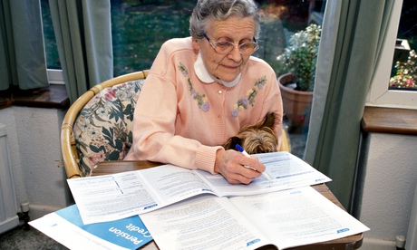 Elderly woman filling in pension credit form