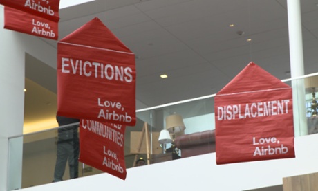 Protesters' banners hung from balloons in Airbnb's atrium