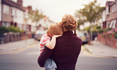 woman holding a child, looking down road