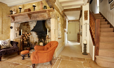 living room with orange armchair and fireplace