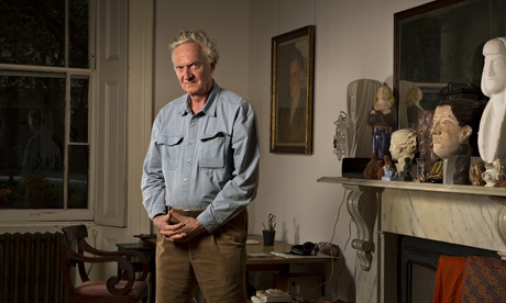 Matthew Spender standing in front of a fireplace