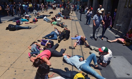 Activists lie on the street pretending to be dead during a flash mob to draw attention to the health risks caused by pollution in Mexico City.