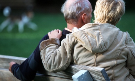Couple sit on park bench