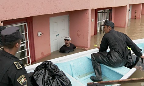 Police rescue a resident trapped by flooding in Mexico City.