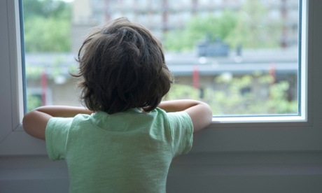 young boy looking out of window