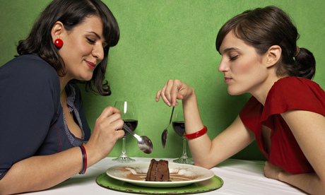 two women share chocolate dessert