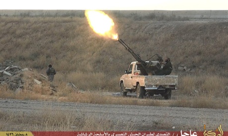 An Islamic State militant fires an anti-aircraft gun from the back of a pickup truck in Hassakeh city, north-east Syria.