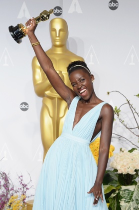 Lupita Nyong'o holding her Oscar