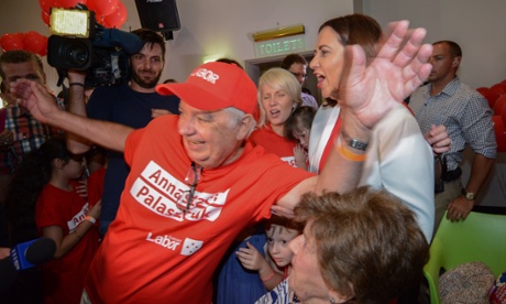 Henry Palaszczuk (L), father of Queensland opposition leader, Annastacia Palaszczuk (R), from the Australian Labor Party, photobombs a family photo at a election night function at Lions Richlands Club in Richlands in Brisbane.