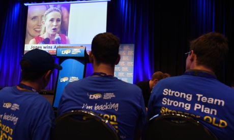 LNP supporters watch Labor's Kate Jones addressing her supporters after winning the state seat of Ashgrove in Brisbane on Saturday.