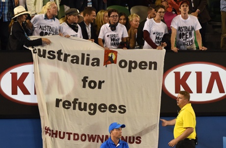 Protestors unfurl a banner.