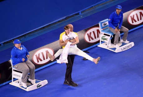 Security guard ejects protestor from court.