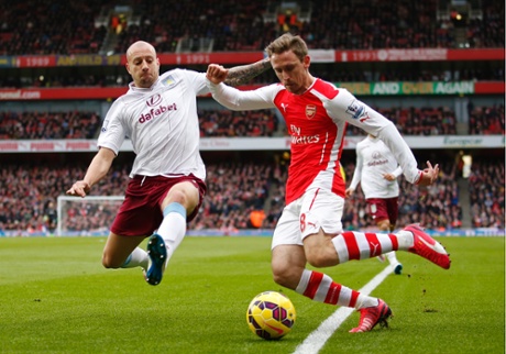 Nacho Monreal cuts one in ahead of Villa's Alan Hutton.
