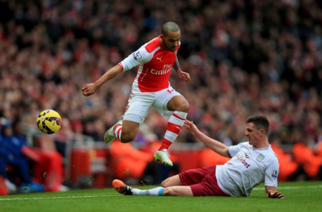Theo Walcott is challenged by Ciaran Clark.