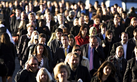Commuters walk across London Bridge