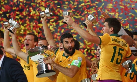 Mile Jedinak seems shocked to be holding the Asian Cup after his side's dramatic victory.