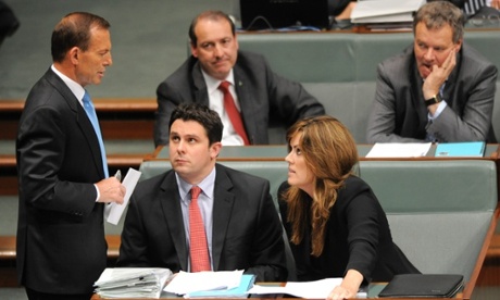 Tony Abbott speaks to his chief of staff Peta Credlin during question time.