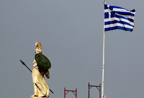 A Greek flag flutters next to a statue of ancient Goddess Athena in central Athens February 10, 2015.