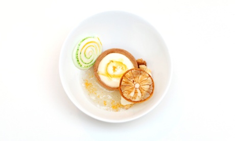 A pastry shell filled with thick lemon mousse next to yuzu sorbet at Wormwood