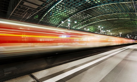 A train speeding past under the arches of the Hauptbanhof station in Berlin