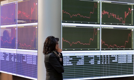 An employee at the Athens stock exchange stands