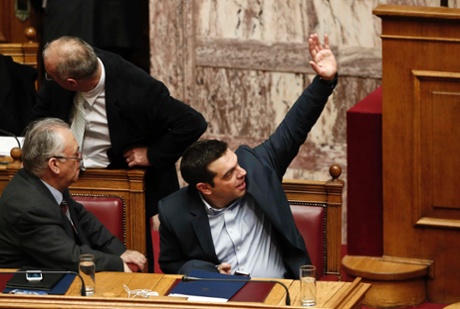 Greek Prime Minister Alexis Tsipras (R) votes during a vote of confidence procedure at the parliament in Athens February 10, 2015.