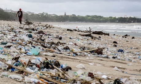 A man walks beside the scattered plastic trash brought in by strong waves at Kuta Beach on January 17, 2014 in Kuta, Indonesia. The sight of trash washed up on Kuta beach has become an annual phenomenon as piles of debris are carried to the beach by strong currents during the winter months. Kuta Beach is one of Bali's top tourist destinations, however during the winter months waste materials are swept up onto the beaches in Java, Bali, and Nusa Tenggara.