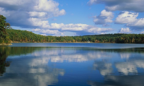 Passing clouds reflect into the shimmering waters of Walden Pond, near Boston, Massachusetts. The lake was made famous by the writings of Henry David Thoreau.